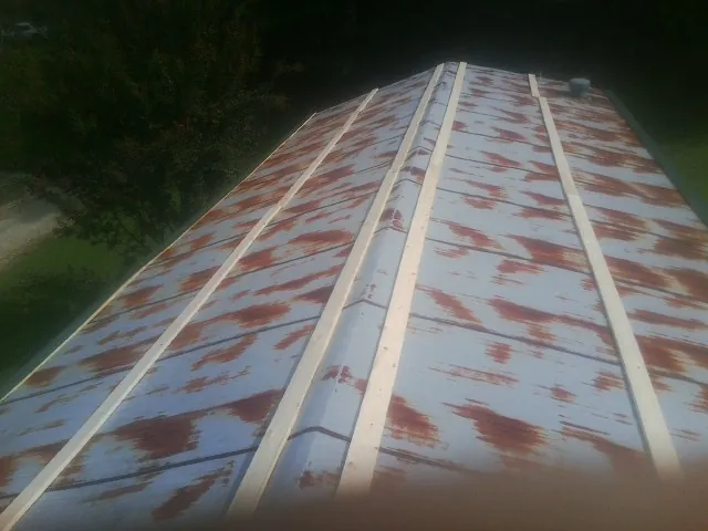 Rusted metal roof panels with new wood purlins before replacement — Storm Damage Roof Repair in Truesdale by Roofing Brothers