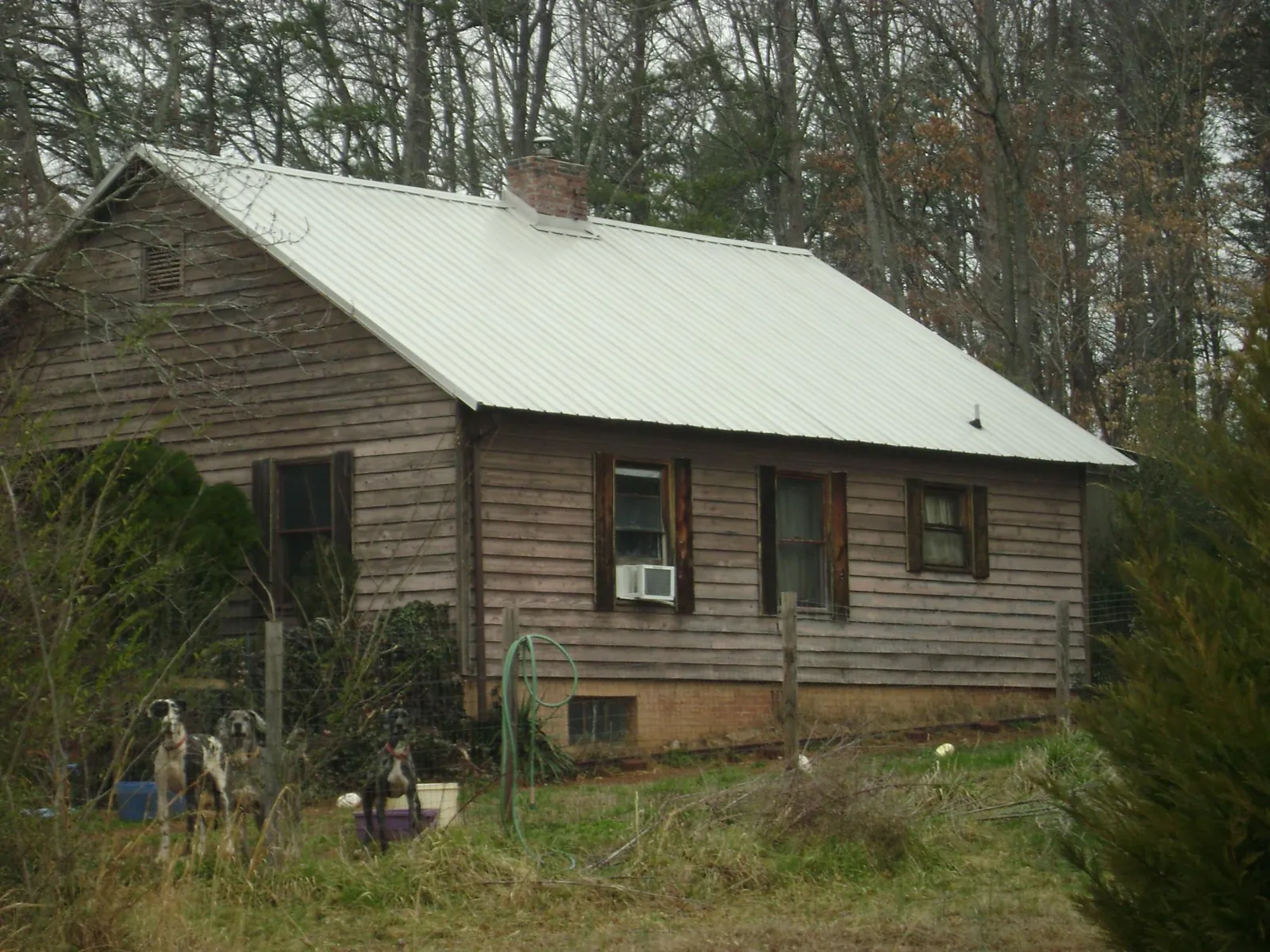 White metal roof on an old wood sided farmhouse, from a Metal Roof Installation job in Truesdale